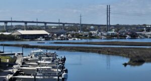 Scenic waterfront marina with docked boats and bridge views — best Father's Day waterfront dining at NC coast