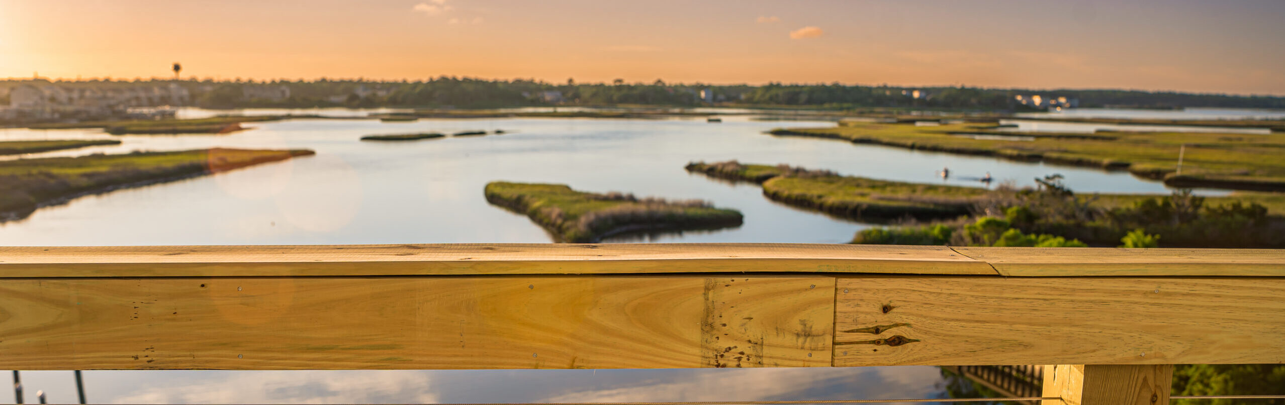Waterfront dining at Marina Joe's — sunset view from the outdoor deck overlooking the Intracoastal waterway and marsh in Surf City, NC.