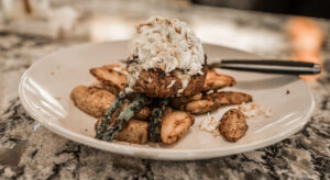 Crab-topped filet mignon with roasted fingerling potatoes and grilled asparagus — Marina Joe's private parties