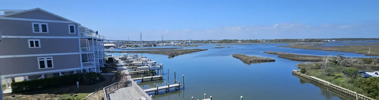 Daytime marina docks and boat slips overlooking Soundside Park near Movies in the Park Soundside Park