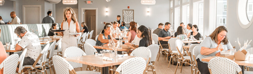 Where to eat before Movies in the Park Soundside - Marina Joe's waterfront dining room with guests enjoying lunch.
